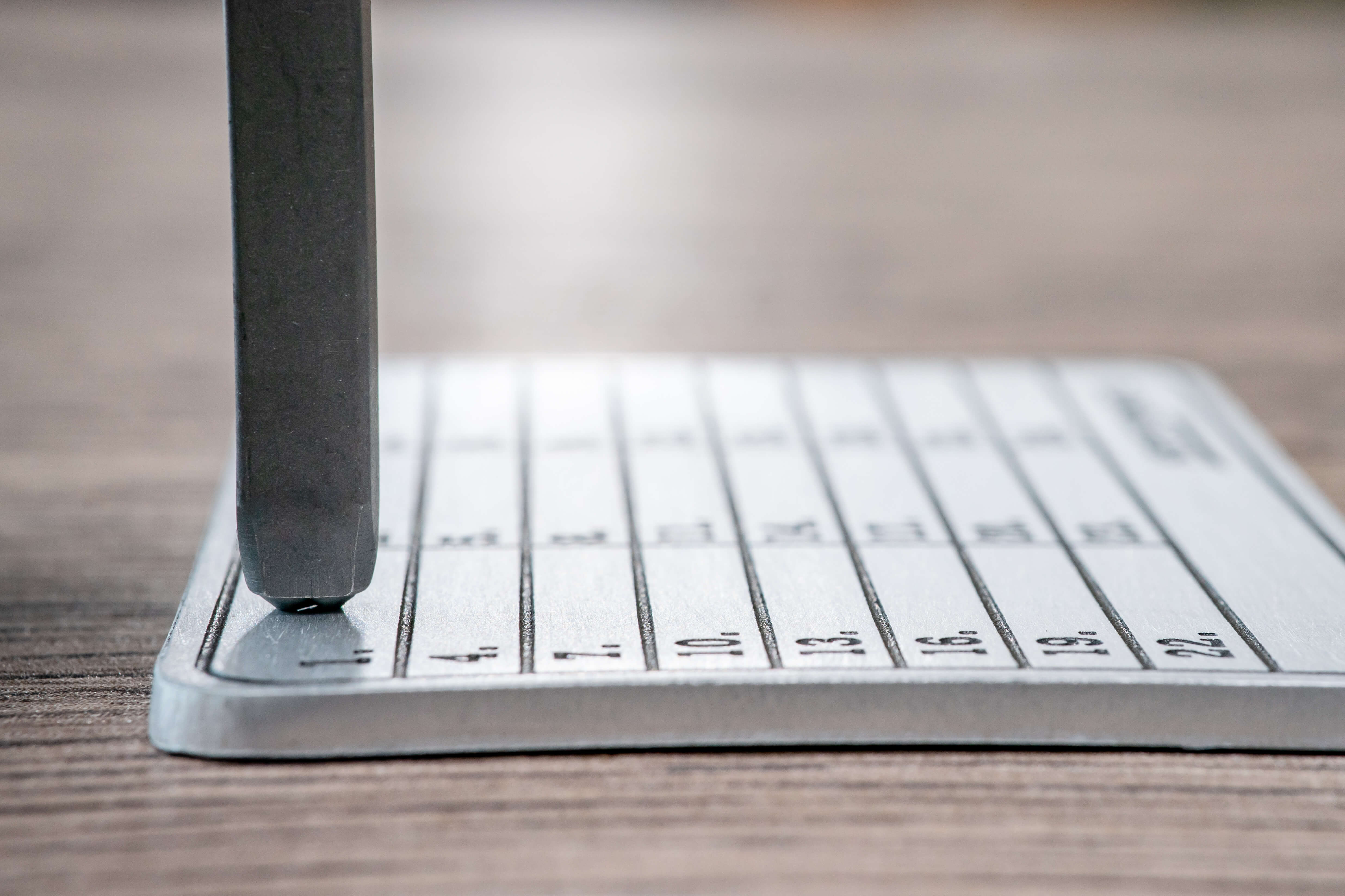 User entering seed phrase into a CryptoTag metal plate for secure cryptocurrency storage